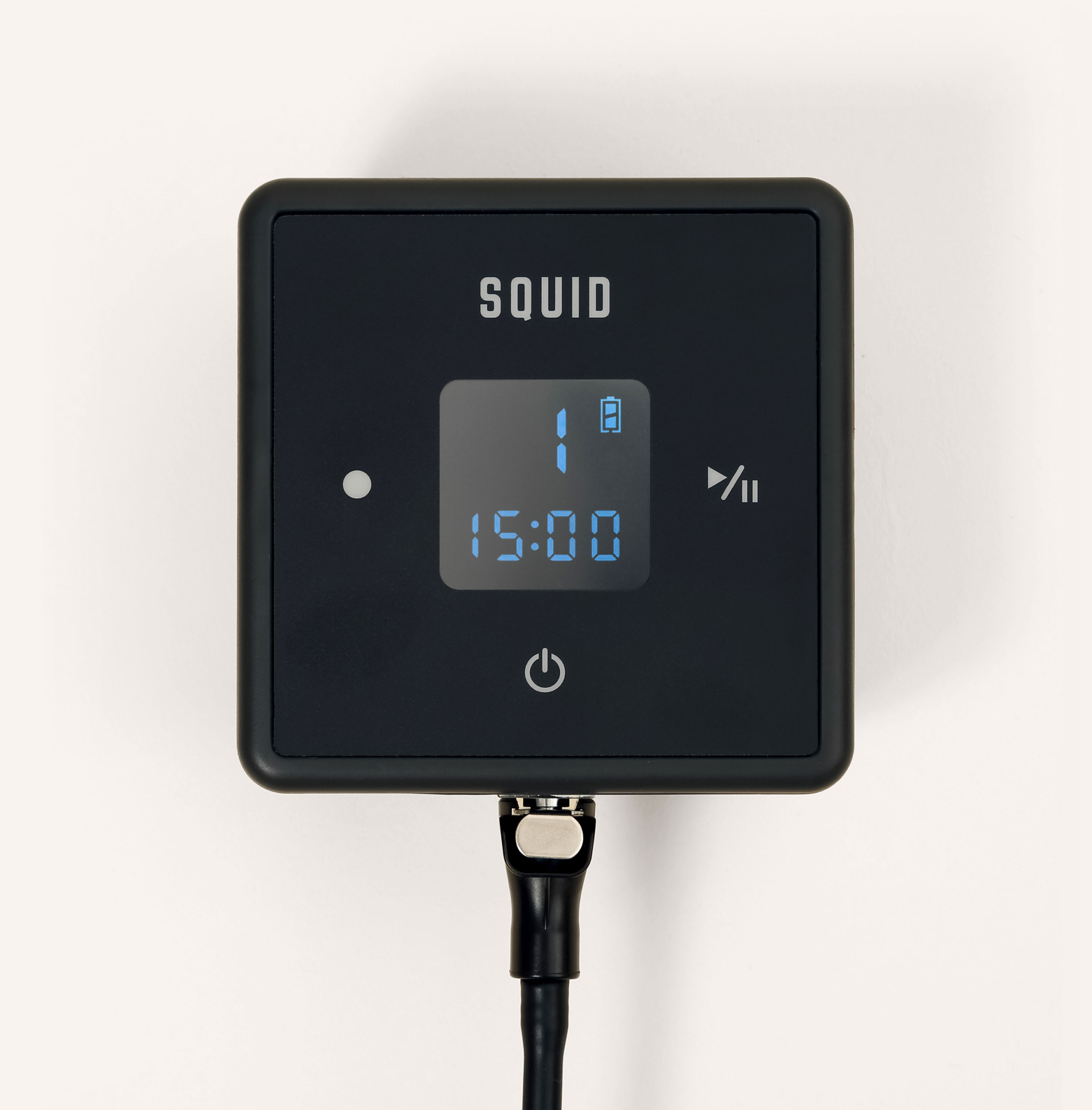 A square black device with a digital display.