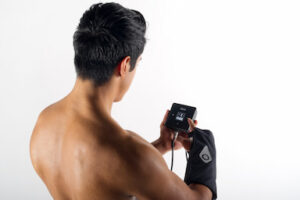 A person adjusting the Squid Go pump while wearing a wrap