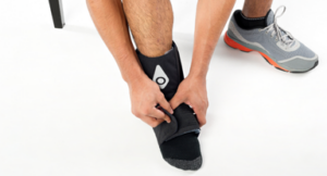 A person wearing the Squid Go ankle cold compression wrap