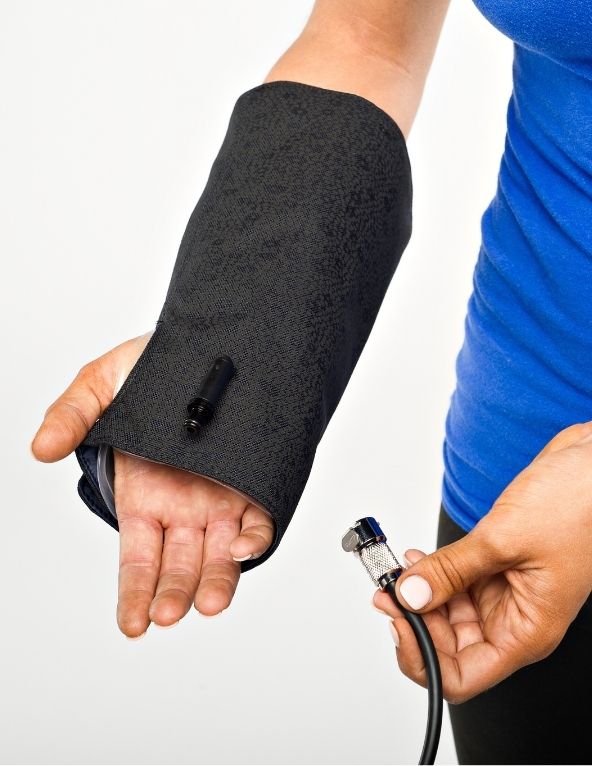 Hands holding a Squid Go wrist wrap and pump