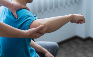 Physical therapist helping with arm pain