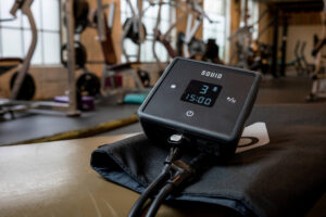 The Squid Go pump and cold compression wrap in a gym